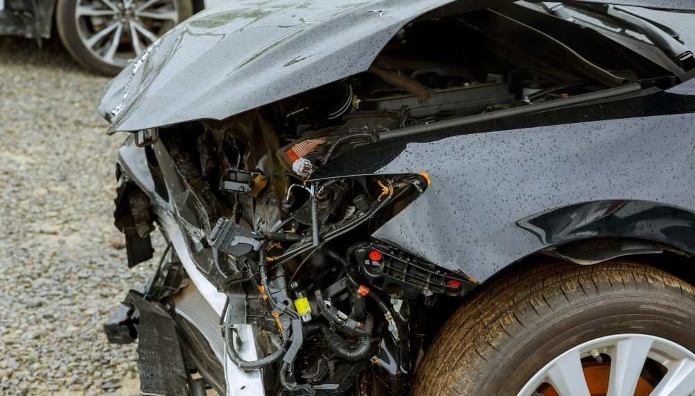 Broken car after accident, view of car front down after an explosion, ready to be scrapped