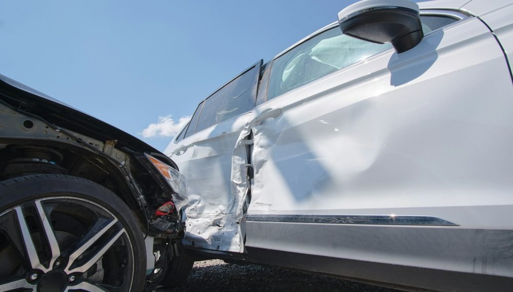 Cars crashed heavily in road accident after collision on city street.