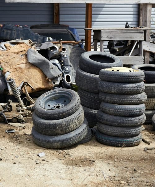 Old used car tires at a junkyard. Rubber tire recycling.