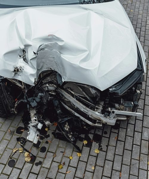 Total accident of a white car after hitting a lamppost. Frontal collision. Deployed airbags during